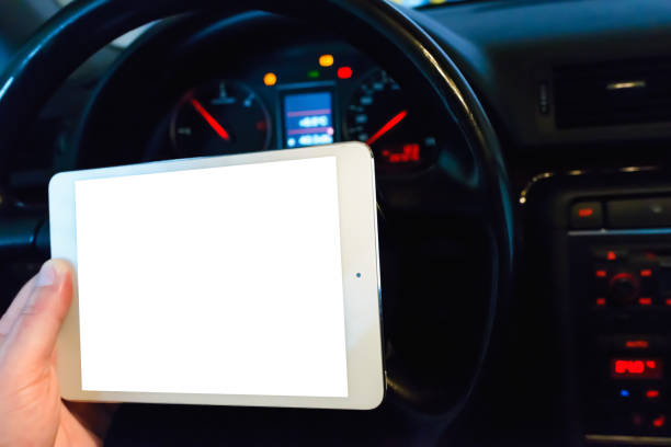istock Mockup white screen.A mechanic looking at pc digital tablet in a car service garage.car engine test dashboard.Transportation service and maintenance working action. 1846951958