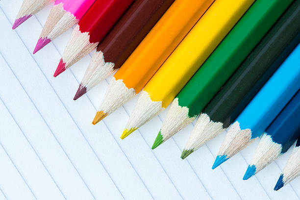 Line of coloured pencils in an arc shape stock photo