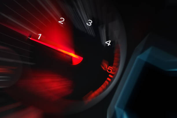 istock Motion blur of a car instrument panel dashboard odometer with red illuminated display.Car speedometer. High speed car speedometer and motion blur at night. 1846958570