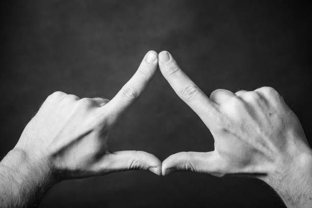 istock Triangle shape made with fingers. Two hands connected together background. 1846962381