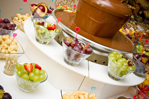 Fruit pieces slices snack in glass bowls. Catering sugar buffet.