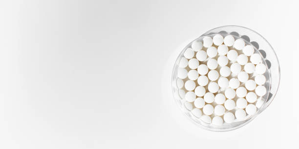 istock White round tablets on a white background. Tablets, minerals and vitamins. Copy space 1846968363