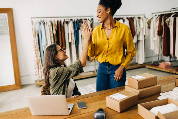 istock Ecommerce success: Female online store owners giving each other a high five in celebration 1846979828