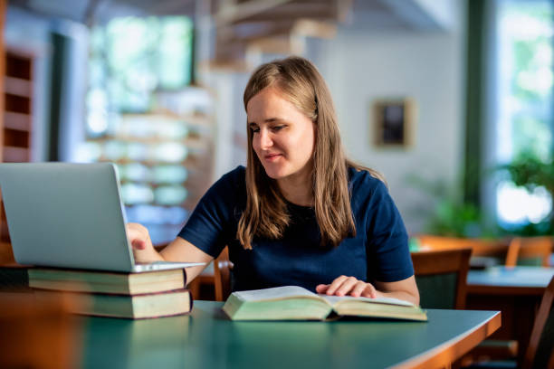 istock A visually impaired woman sitting and studying in the university library 1847002309