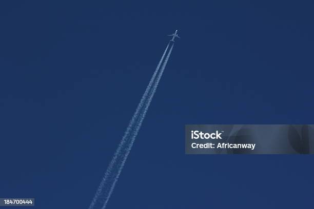 Blue Sky White Condensation Trail Of An Airplane Stock Photo - Download Image Now - Air Vehicle, Airplane, Blue