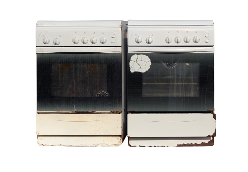 Two old gas stoves isolated on a white background. Recycling of household appliances.