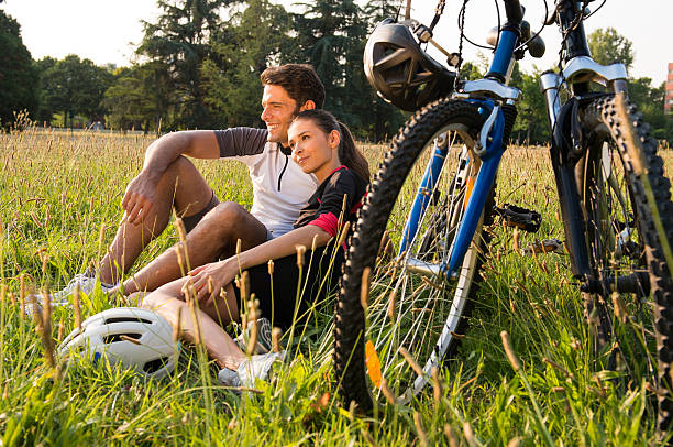 Tired bicycle lying in the grass at the roadside