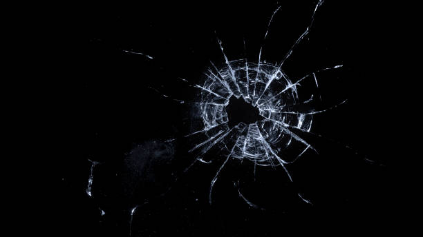 Close-up of bullet hole on glass