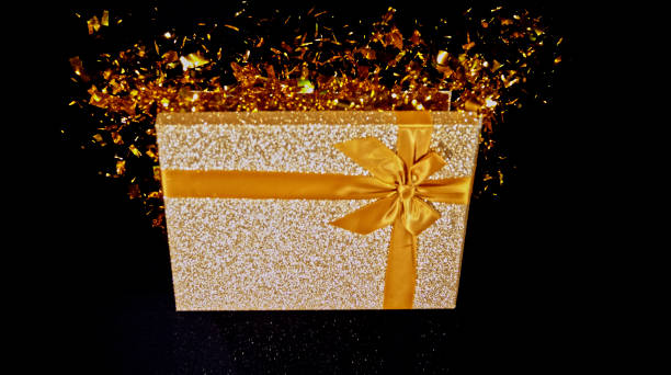 istock Gold coloured gift box with confetti 1847012267