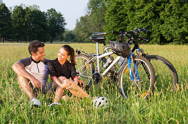 istock Young Couple Cycling In Meadow 184701445