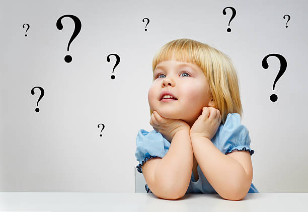 istock Young blonde girl with questions marks all around 184701455