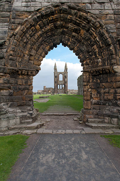 The inside of St. Andrews Abbey in Scotland through the front archway on a sunny day.