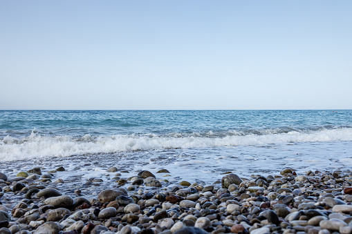 Low sea waves on the pebbly beach of the Adriatic Sea