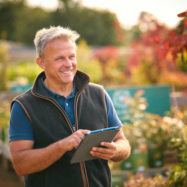 istock Portrait Of Mature Man Working Outdoors In Garden Centre Using Digital Tablet 1847028361