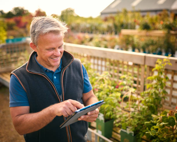 istock Portrait Of Mature Man Working Outdoors In Garden Centre Using Digital Tablet 1847031392