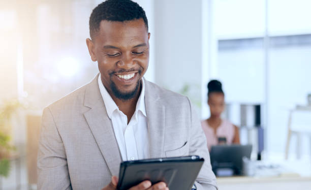 istock Business, smile and black man with a tablet, internet and network with website information, lens flare and online reading. African person, consultant and employee with tech, connection and research 1847032057