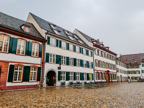 Modestly decorated buildings and pedestrian zone on Minster Cathedral Square (Müensterplatz) in Basel, Switzerland.
