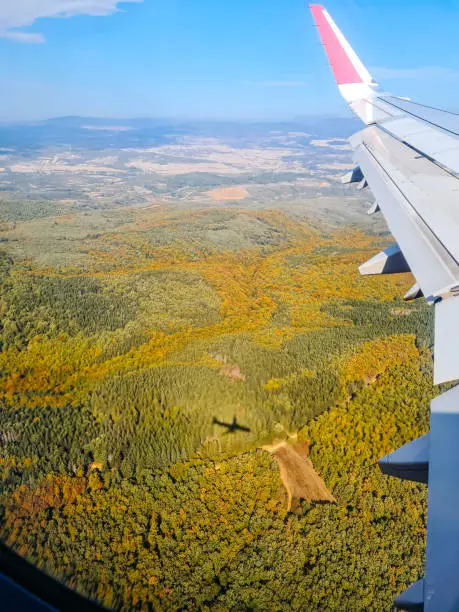 Photo of View Of Green Hills In Serbia From The Airplane Window Mid-Air