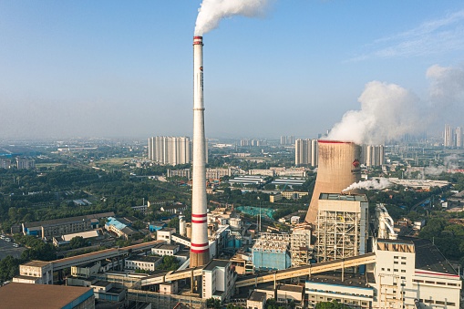 Wuhan, China – August 04, 2023: An aerial view of Wuhan Qingshan Thermal Power Station with smoke stacks and industrial structures