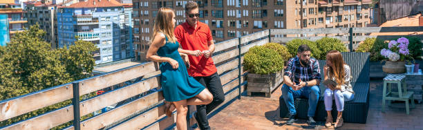 istock Couple talking next to friends in rooftop on a summer day 1847046313