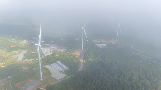 Beautiful landscape in the morning at Cau Dat, Da Lat city, Lam Dong province. Wind power on tea hill, morning scenery on the hillside of tea planted in the misty highlands below the beautiful valley