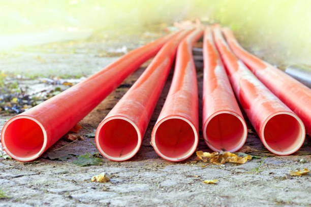 istock Red plastic communication water pipes on a construction site in sunlight 1847051933
