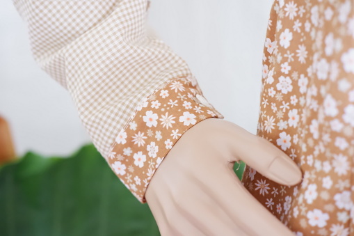 Close up of a mannequin's hand with a flower pattern