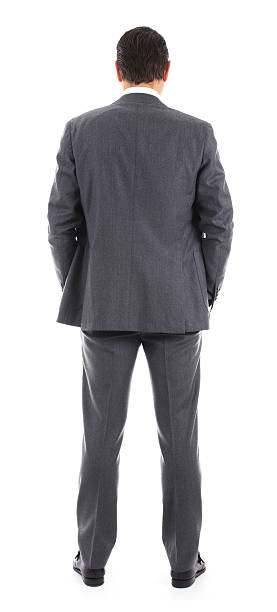 Businessman from behind Businessman standing with back to the camera turning back stock pictures, royalty-free photos & images