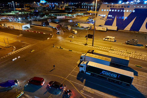 Olbia, Italy - October 02, 2023: cars, campers and trucks embarking into multiplke ferry ships at Port of Olbia.