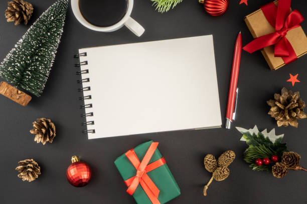istock Holiday decorations and notebook on black table from above, Christmas planning concept. 1847076759