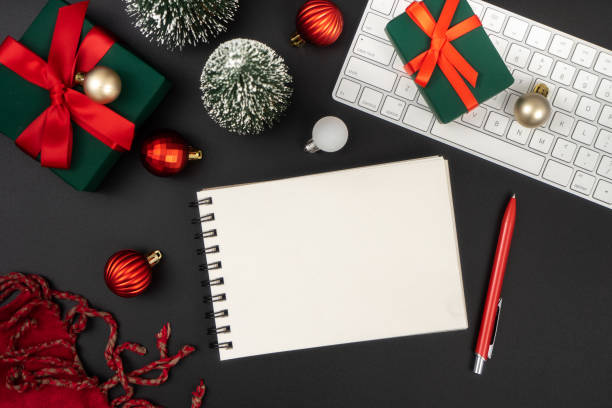 istock Holiday decorations and notebook on black table from above, Christmas planning concept. 1847078517