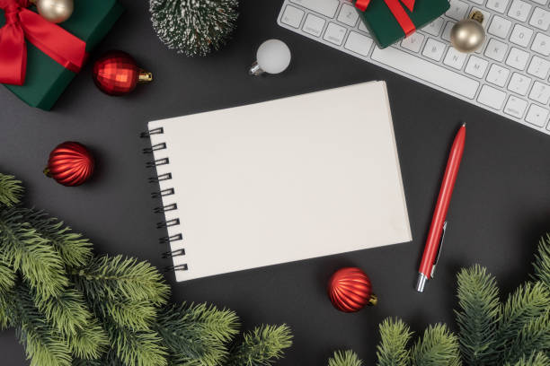 istock Holiday decorations and notebook on black table from above, Christmas planning concept. 1847079115