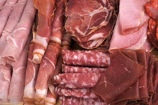Assortment of cold meats close- on background