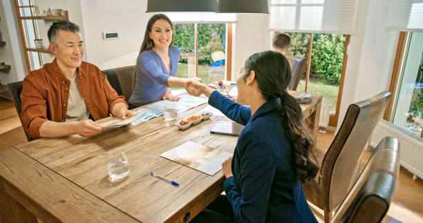istock Couple handshaking with financial advisor 1847139982