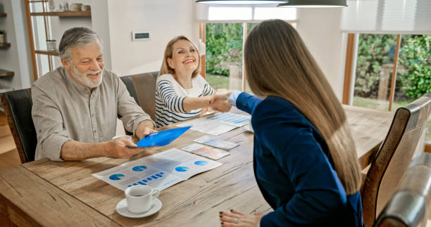 istock Senior couple handshaking with financial advisor 1847140030