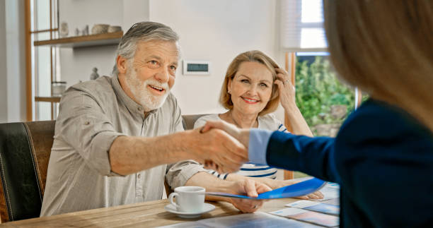 istock Senior couple handshaking with financial advisor 1847140038
