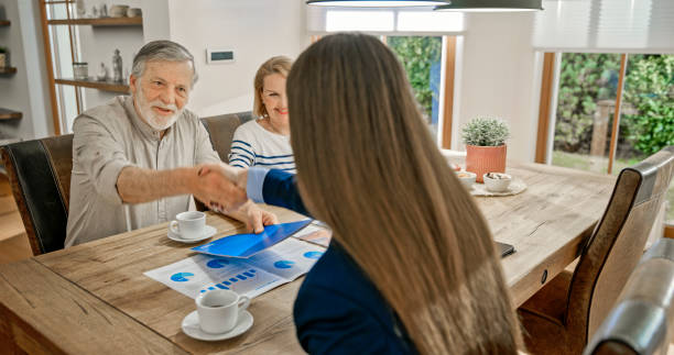 istock Senior couple handshaking with financial advisor 1847140044