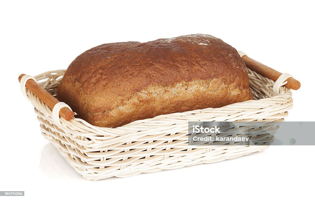 Brown bread in basket Brown bread in basket. Isolated on white background Basket Stock Photo