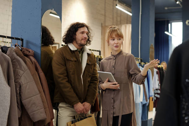 istock Young blond woman with tablet pointing at new winter collection 1847142906