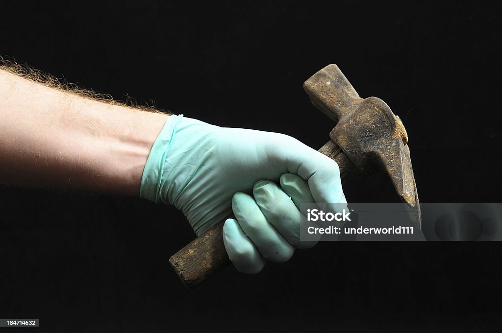Hammer and a Hand Hammer and a Hand on a Black Background Adult Stock Photo
