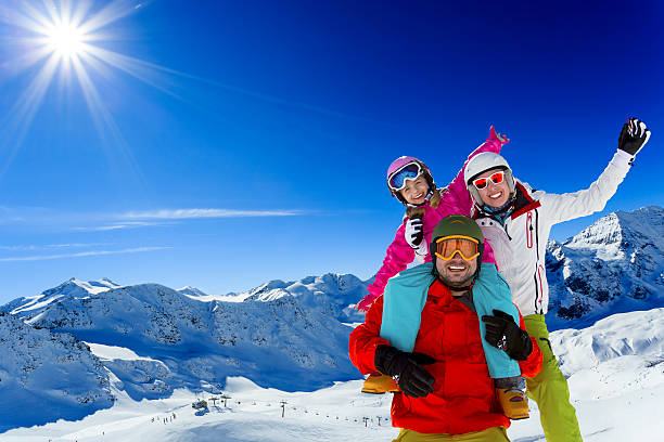 Ski family enjoying winter Ski, skier, sun and winter fun - family skiers  enjoying winter holidays ski holiday stock pictures, royalty-free photos & images