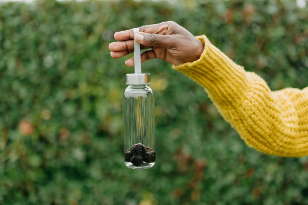 One african american woman holding plastic container