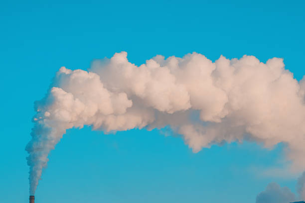 istock Smoke from chimney against blue sky. Ecological problem. Release of carbon dioxide into atmosphere 1847169084