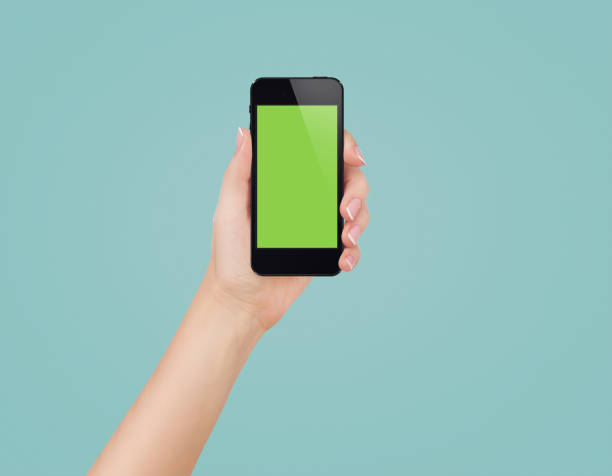 istock Female hands holding mobile phone with blank screen isolated 1847183618