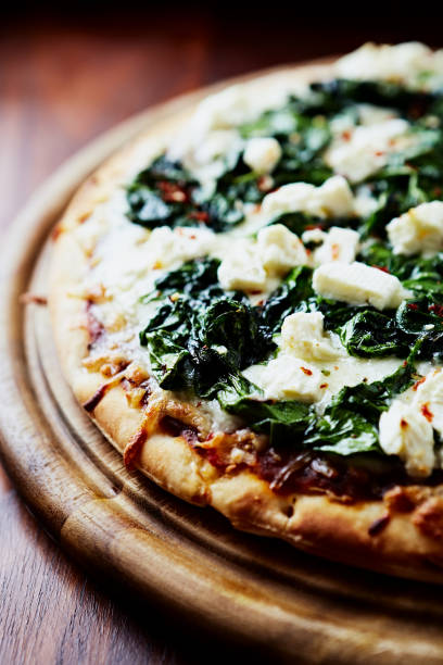 Pizza with mozzarella cheese and spinach. Close up.