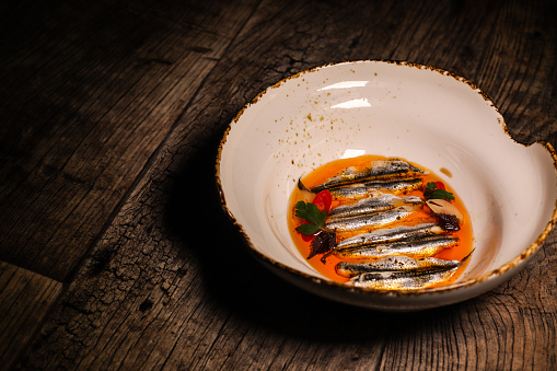 Handmade traditional Spanish marinated sardines Boquerones served with olive oil pil-pil