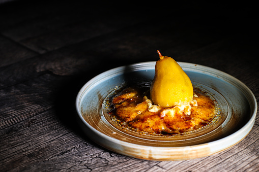 Traditional Crema Catalana with pear cooked in cider and saffron