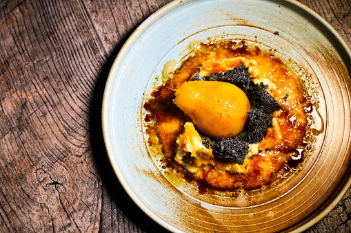 Traditional Crema Catalana with pear cooked in cider and saffron