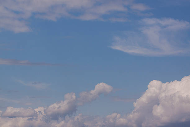 Cumulus and cirrus clouds stock photo