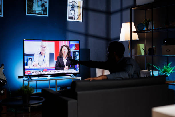 istock Concerned citizen watching breaking news program on tv 1847268223